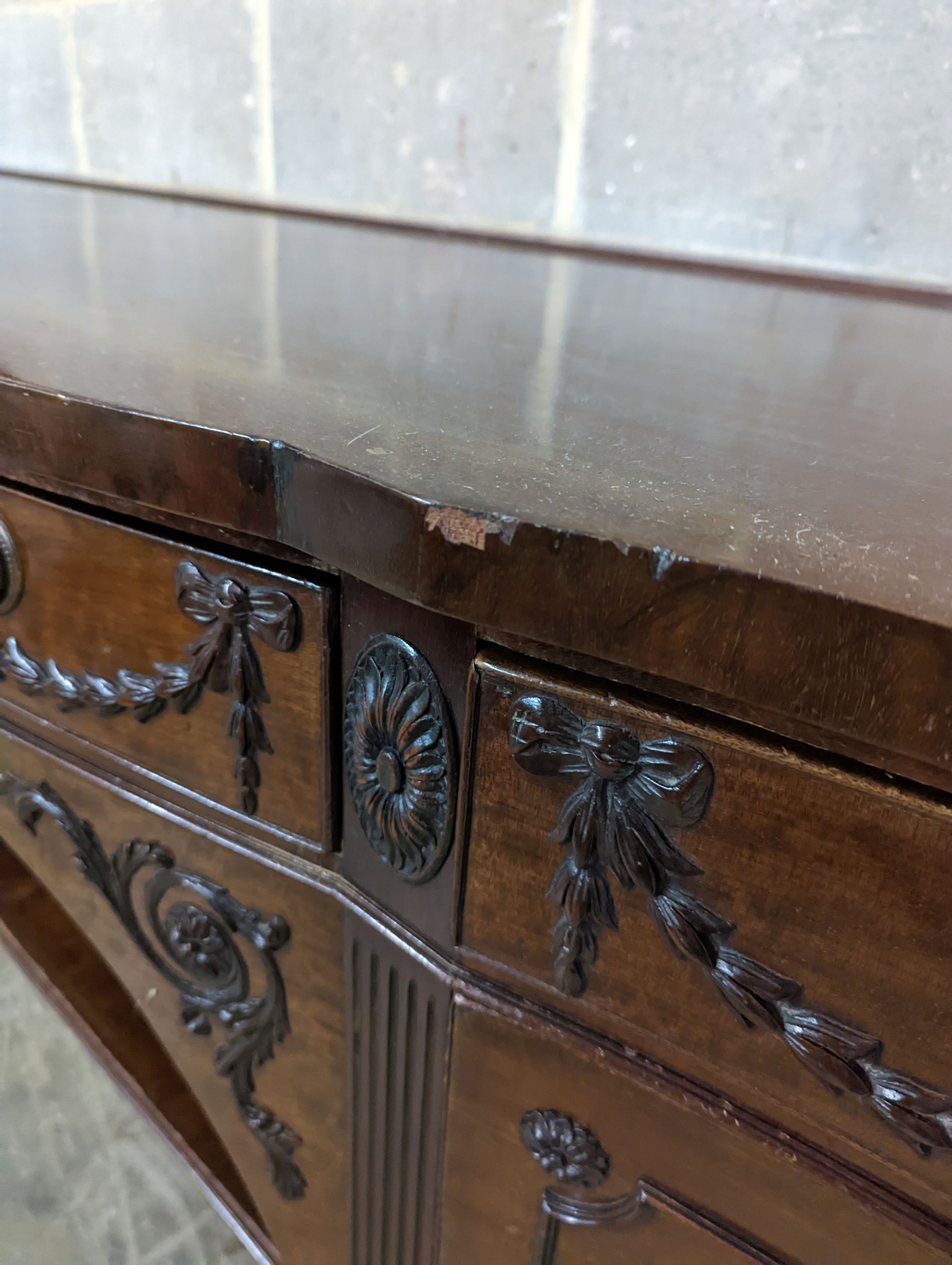 An early 20th century Adam design mahogany serpentine sideboard, length 214cm, depth 68cm, height 92cm